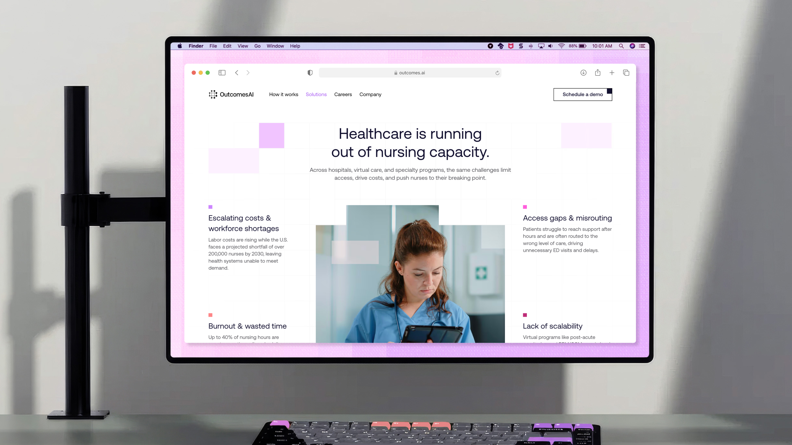 The redesigned OutcomesAI site shown on a desktop monitor